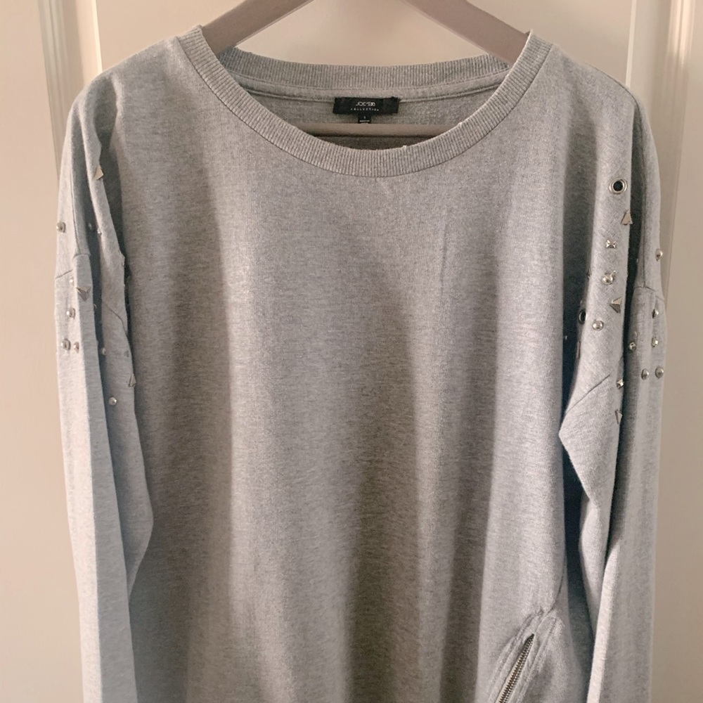 Joe’s Jeans distressed sweatshirt with grommets.